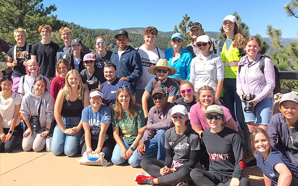 student and prof sitting and talking on sofa